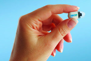 hand holding pill cam