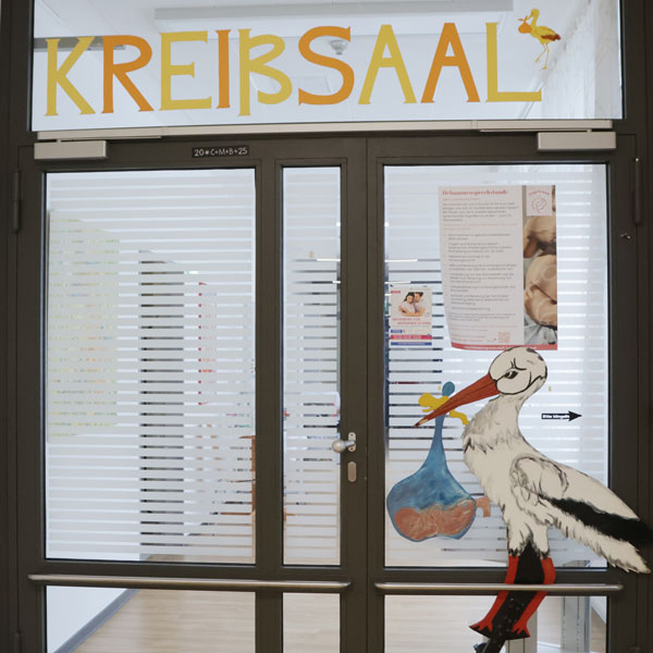 Eingang zum Kreißsaal mit Storchfigur