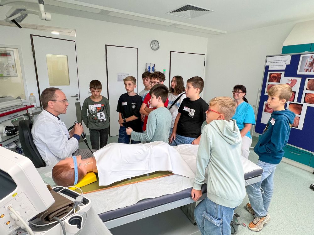 Kinder testen verschiedene medizinische Aufgaben an einer Puppe